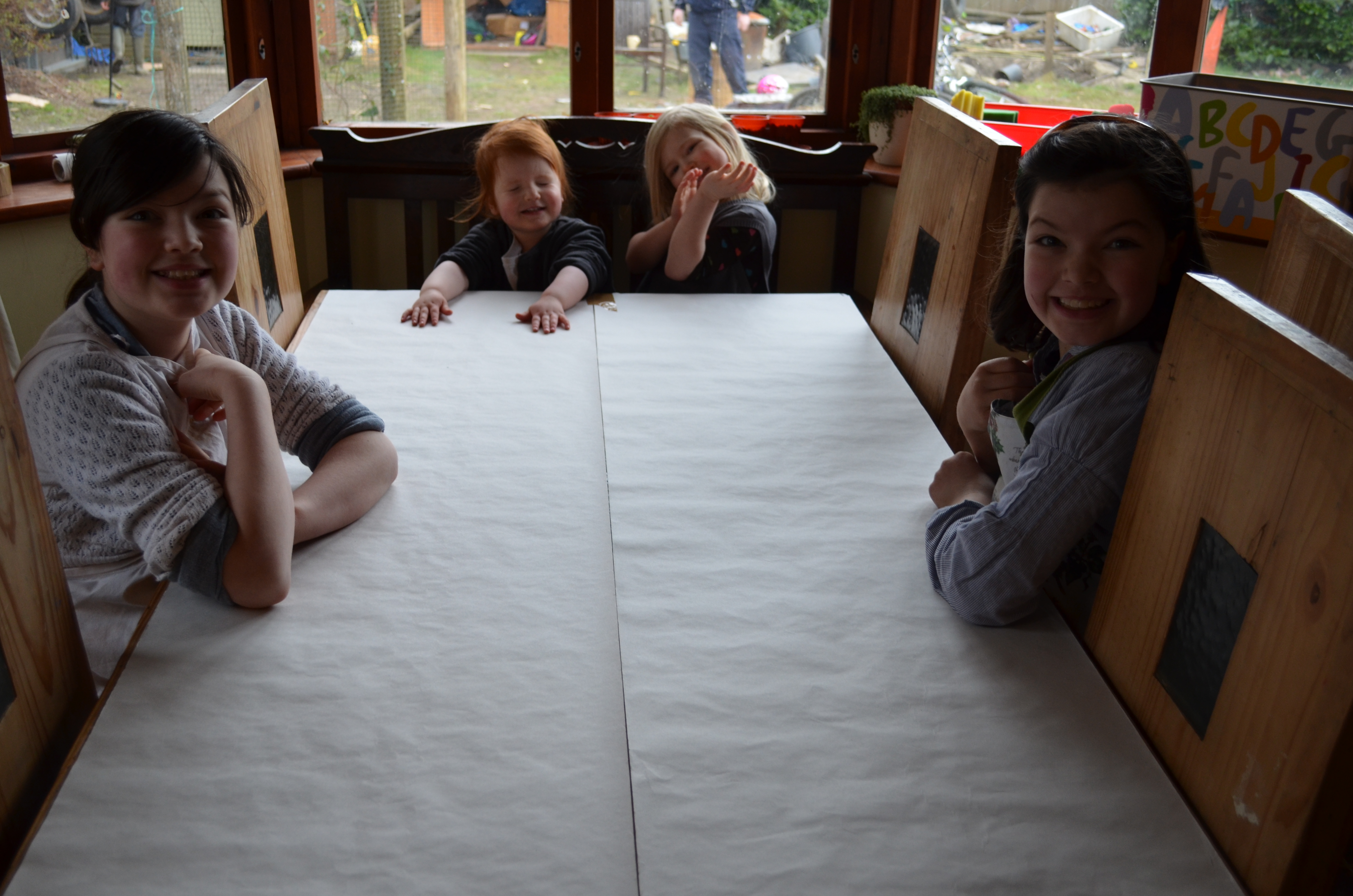 First I covered the table with lining paper, taping it down at both ends.  I gave the two younger children tops which T11 had grown out of, to protect their clothes