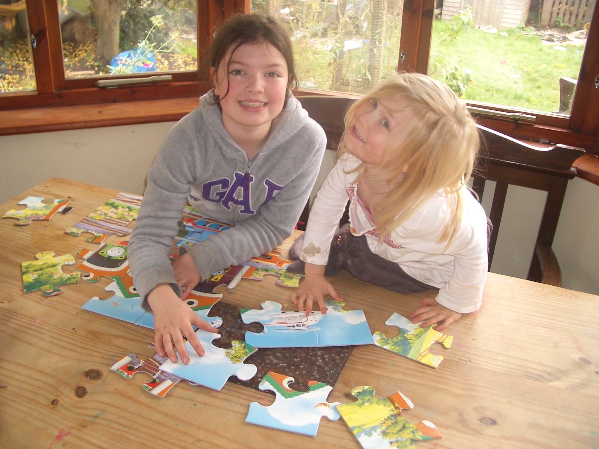 two girls doing Thomas the tank engine puzzle