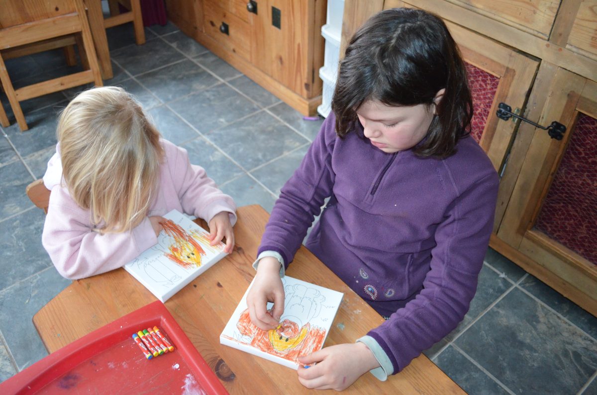Big sister doing activity trays with younger sister